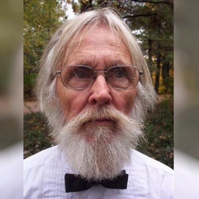 Older man with glasses and white hair, beard and mustache